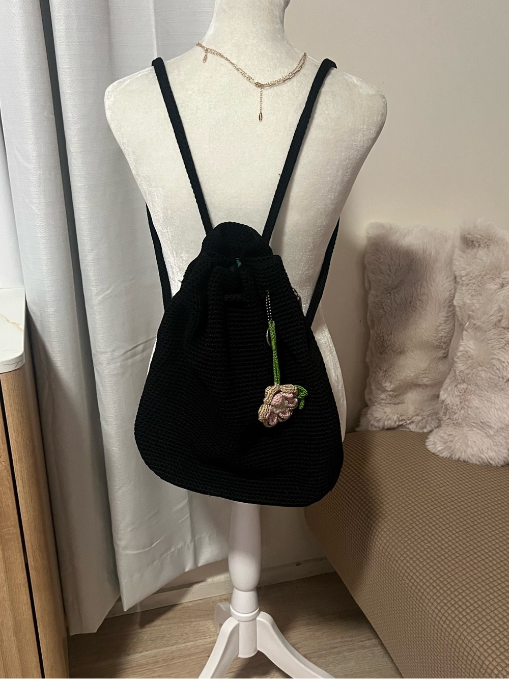The Sak Black Knit Drawstring Backpack with Pink Floral Charm